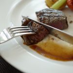 Rosa gebratenes Kalbsrückensteak an weißem Spargel mit Sauce Hollandaise und Reiberdatschi